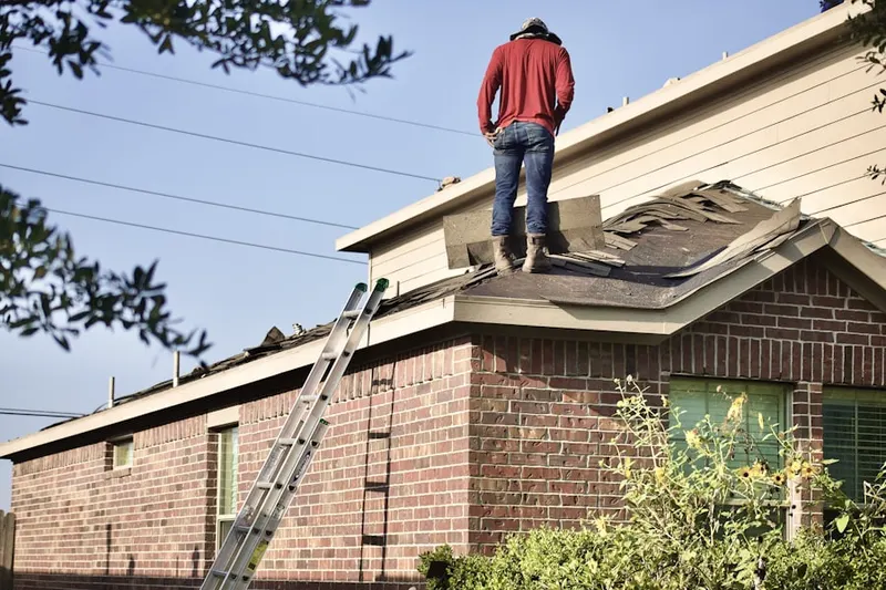 Professional roofer working on a residential roof in Gulf Bridge